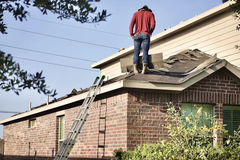 Professional roofer working on a residential roof in North State